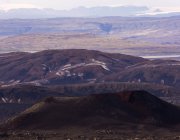 Вид на скелясті вулканічні утворення в оточенні горбистої сухої гори — стокове фото