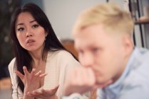 Donna asiatica infelice che prende a uomo indifferente durante sessione di terapia in carica di psicologo — Foto stock