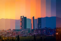 Contemporary multistage building exteriors against lush trees under colorful sky at sundown in Madrid Spain — Stock Photo
