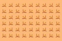 Top view of ornament of plastic toy airplanes arranged in rows on orange background — Stock Photo