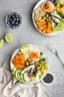 Top view of plates with delicious fresh apple and lime slices near sweet potato wedges and olives with hummus on table — Stock Photo