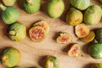 Спелые сладкие зеленые инжиры, свежесобранные с домашнего дерева на доске для резки древесины. Также известный как спелые белые инжиры — стоковое фото