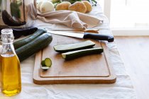 High angle of various fresh ingredients prepared for cooking appetizing zucchini cream soup at home — Stock Photo