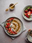 Closeup of a delicious plate of strawberry porridge on a table in the kitchen — Stock Photo