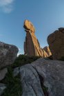 Desde abajo de la formación de piedra ornamental situada en las tierras altas del Parque Nacional Sierra de Guadarrama en el cielo azul - foto de stock
