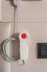 Close up of nurse call system with emergency buttons installed near bed in medical room in hospital — Stock Photo