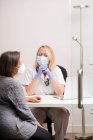 Female doctor attending a patient in her medical office — Stock Photo