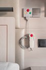 Nurse call system with emergency buttons installed near bed in medical room in hospital — Stock Photo