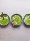 Top view of delicious pea cream soup in bowls served on table — Stock Photo