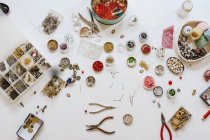 Top view of assorted beads instruments and threads with various bugle and spangle for creating accessories — Stock Photo
