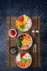 Delicious poke bowl with many ingredients seen from above — Stock Photo