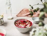 From above of tasty smoothie with fresh berries and ice candy with crushed pistachios and yogurt in bowl — Stock Photo