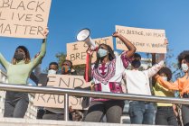 From below of crowd of multiracial protesters with placards and megaphone standing on street during Black Lives Matter protest — Foto stock