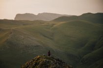 Сверху анонимный турист на вершине скалы над горной долиной в Испании — стоковое фото