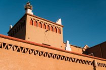 Dal basso della vecchia costruzione in pietra con cielo azzurro chiaro sullo sfondo in Marocco — Foto stock