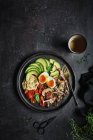 Overhead full plate of delicious dish with hummus from fried champignons and boiled eggs with tomatoes and avocado served fresh leaves of basil — Stock Photo