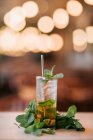 Cold mojito cocktail made of rum lime and mint leaves served with ice cubes and reusable straw — Stock Photo