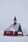 Wooden exterior of Svalbard Church located in mountains in snowy valley in winter — Stock Photo