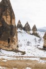 From above dirt road against snowy hill with famous pillars with sharp spear shaped peaks in national park in Turkey — Stock Photo