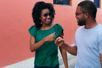 Black couple walking on the street and looking at each other — Stock Photo