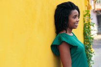 Beautiful young woman with afro in the street — Stock Photo