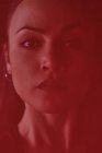 Crop junge Frau mit roten Lippen blickt in die Kamera hinter transparentem Textil mit Falten — Stockfoto