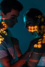 Artistic image of affectionate couple showing love under projector lights — Stock Photo