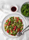 Top view of delicious salad with arugula and quince served on plate with sauce on table — Stock Photo