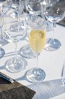 Glass of champagne at outdoor high cuisine restaurant — Stock Photo