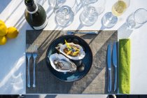 Delicious and well decorated oyster's dish paired with champagne at outdoor high cuisine restaurant — Stock Photo