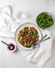 Top view of delicious salad with arugula and quince served on plate with sauce on table — Stock Photo