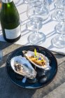 Delicious and well decorated oyster 's dish paraired with champagne at outdoor high cuisine restaurant — стоковое фото