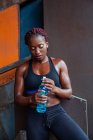 Спортивна етнічна жінка п'є воду — стокове фото