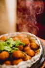 Delicious hot taro with steam fried in foil on wooden table in restaurant — Stock Photo