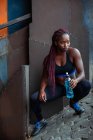 Atlética mujer étnica agua potable - foto de stock
