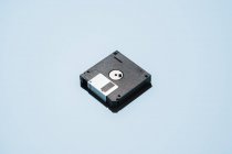 From above of stack of black floppy disks placed on light blue background — Stock Photo