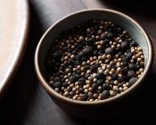 Closeup of a plate full of peppercorns viewed from above — Stock Photo
