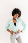 Young attractive African American female with beautiful afro hair in trendy outfit on white background — Stock Photo