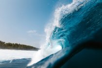 Puissantes vagues de mer mousseuses roulant et éclaboussant sur la surface de l'eau contre le ciel bleu — Photo de stock