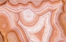 Macro of abstract background of agate gemstone with white and red spots and lines in lagoon in Mexico — Stock Photo