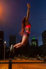 Ethnic athlete jumping on street — Stock Photo
