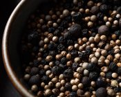 Closeup of a plate full of peppercorns viewed from above — Stock Photo