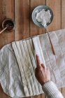 Vista superior da pessoa anônima cortando massa fina na mesa de madeira perto de queijo creme e geléia de figo durante a preparação de pastelaria — Fotografia de Stock