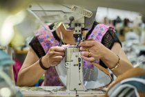 Détail des mains du travailleur faisant de la couture dans le cuir des chaussures à l'usine de chaussures chinoise — Photo de stock