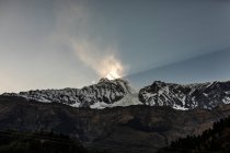 Amazing scenery of bright sunlight beam illuminating mountain peak in Himalayas in winter in Nepal — Stock Photo