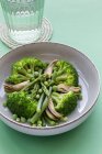 Closeup viewed from above of a vegetable dish with broccoli, mushrooms and peas — Stock Photo