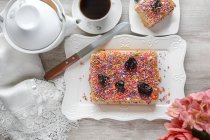 Top view delicious traditional Turron de Dona Pepa dessert with colorful dragee served on plate on table — Stock Photo