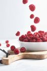 Side view of raspberries in a bowl on a wood isolated on a white background — Stock Photo