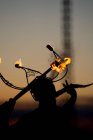 Femme mangeuse de feu qui crache du feu au coucher du soleil — Photo de stock