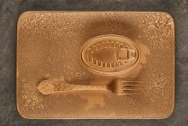 Vue de dessus de la fourchette en or placée près des aliments en conserve scellés sur un plateau rectangulaire en cuivre — Photo de stock